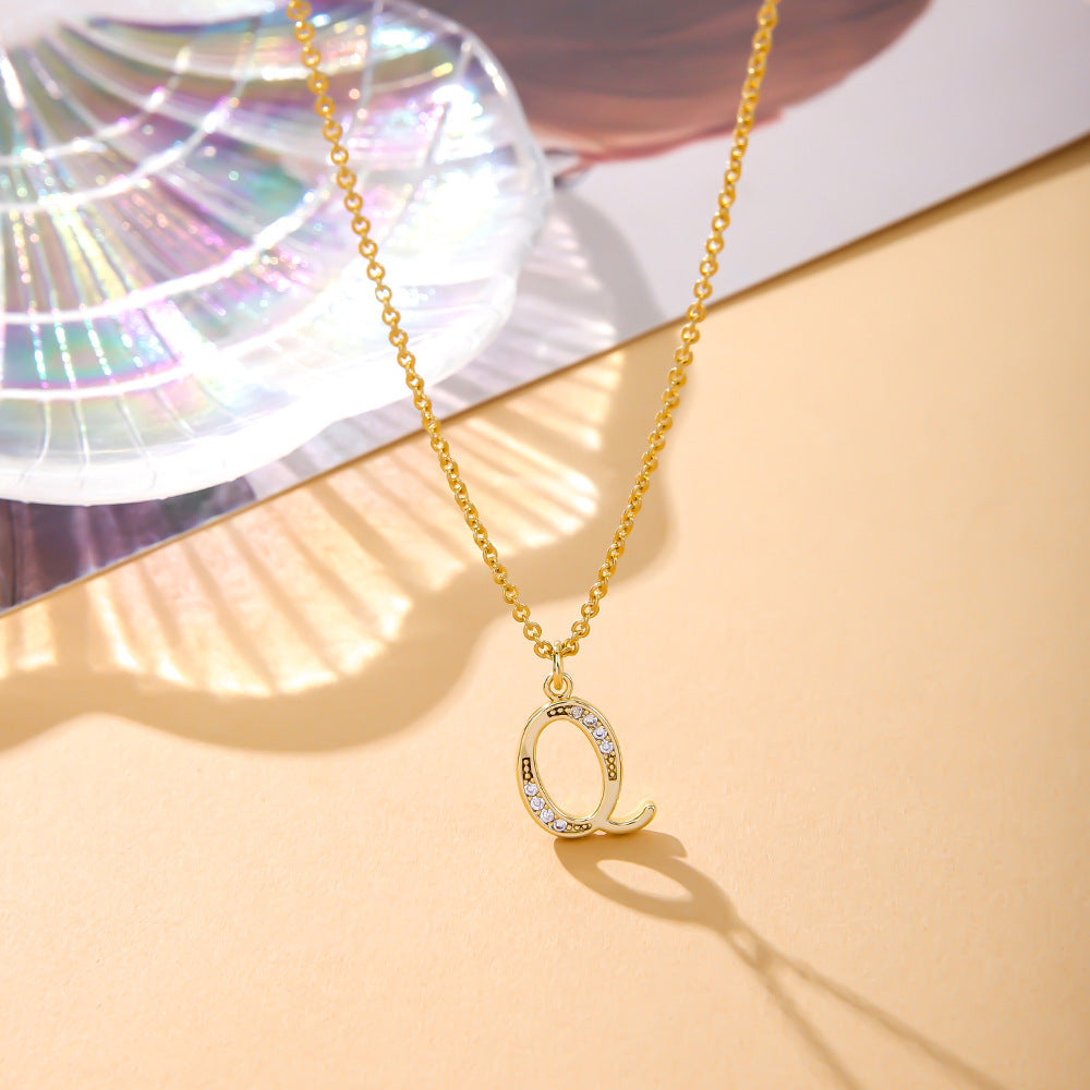 The K.Bola Fashion English Necklace showcases a Q pendant inlaid with zircon crystals on an O-shaped chain, reflecting colorful light patterns.