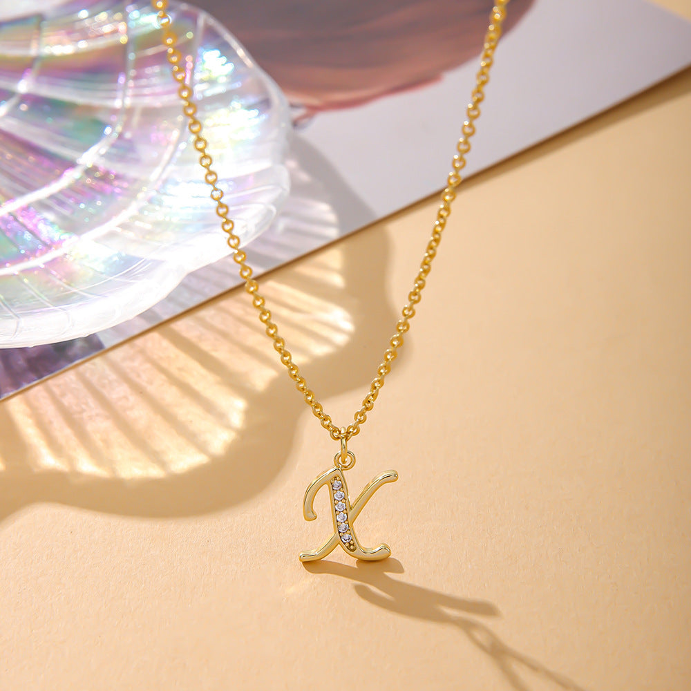 The K.Bola Fashion English K Zircon Copper Necklace, featuring a letter-shaped pendant with crystals, offers elegance for women. Displayed on a pastel background with an iridescent shell, this alloy piece is an exquisite addition to any collection.